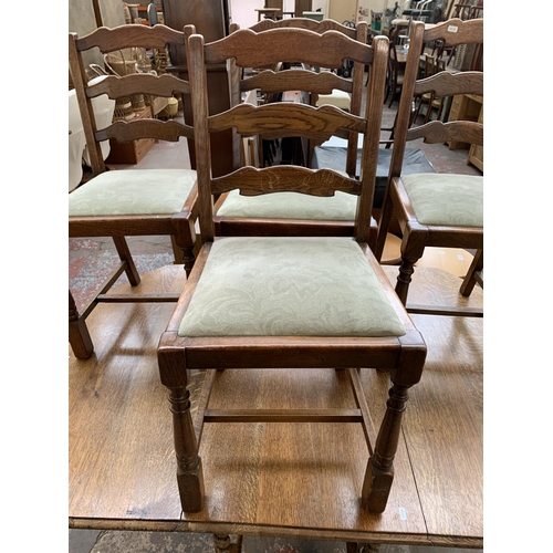 260 - An early 20th century oak drop leaf gate leg dining table on barley twist supports and four oak ladd... 