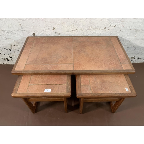 264 - A mid 20th century teak nest of tables with ceramic tile inserts - approx. 39cm high x 84cm wide x 4... 