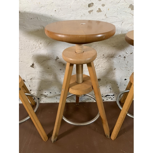 267 - Three modern beech adjustable bar stools - approx. 80cm high x 31cm diameter