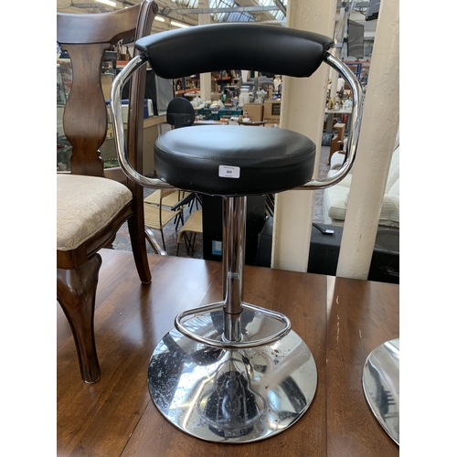 283 - A pair of modern black leatherette and chrome plated kitchen bar stools