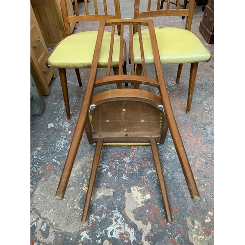 287 - Three mid 20th century Czechoslovakian beech and yellow vinyl upholstered dining chairs