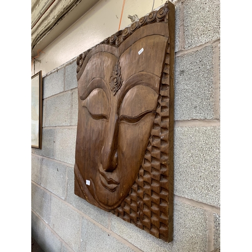 29 - A carved teak buddha wall plaque - approx. 75cm high x 62cm wide