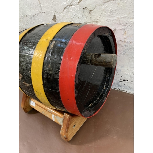 293 - A vintage painted wooden barrel on stand -approx. 38cm high x 43cm wide x 32cm deep