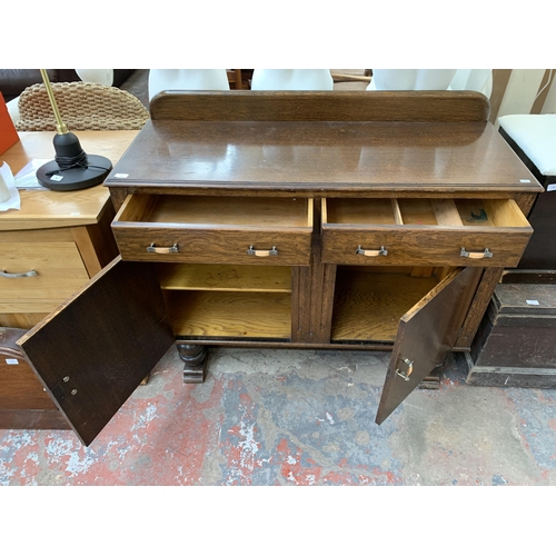 294 - An Art Deco oak sideboard - approx. 108cm high x 124cm wide x 46cm deep