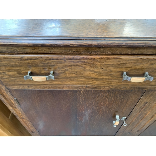 294 - An Art Deco oak sideboard - approx. 108cm high x 124cm wide x 46cm deep