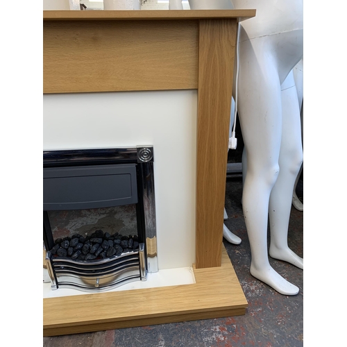 300A - A modern oak fire surround with electric fire - approx. 112cm high x 120cm wide x 38cm deep