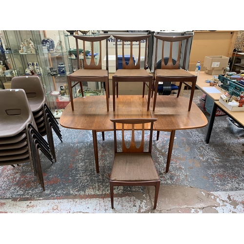 300I - A mid 20th century teak extending dining table and four G Plan Brasilia teak and fabric upholstered ... 