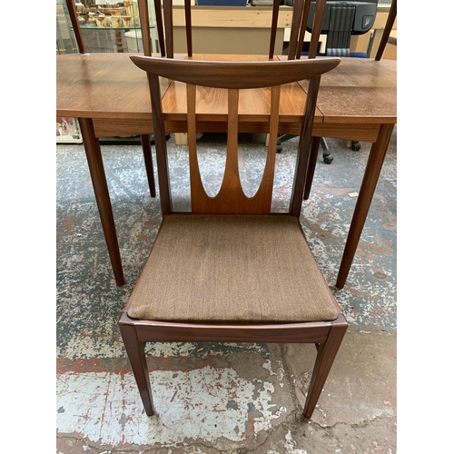 300I - A mid 20th century teak extending dining table and four G Plan Brasilia teak and fabric upholstered ... 