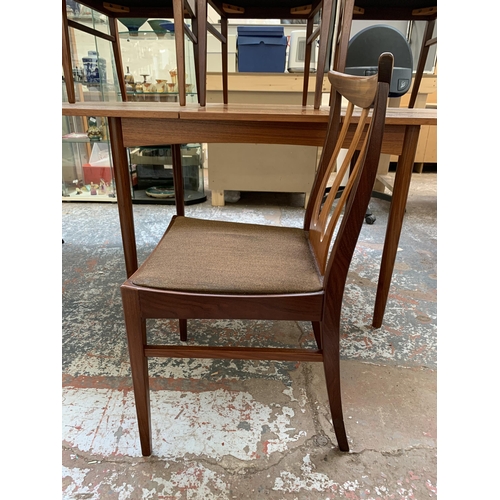 300I - A mid 20th century teak extending dining table and four G Plan Brasilia teak and fabric upholstered ... 