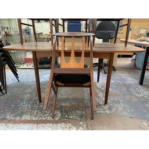 300I - A mid 20th century teak extending dining table and four G Plan Brasilia teak and fabric upholstered ... 