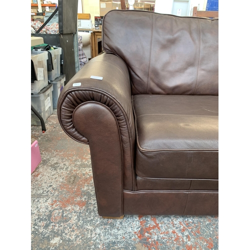 300N - A Marks & Spencer brown leather two piece lounge suite comprising three seater sofa and armchair