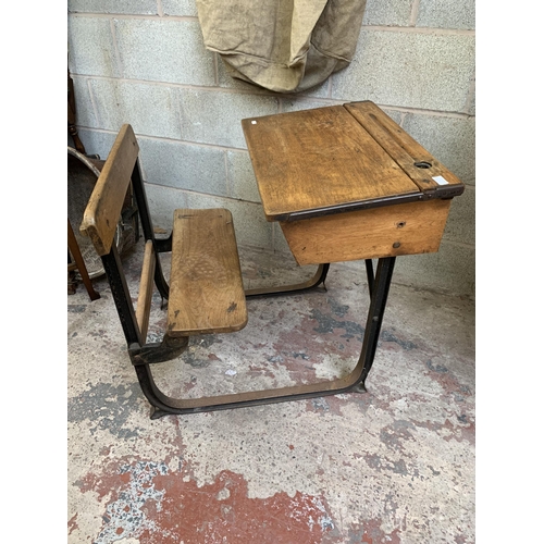 35 - An early 20th century beech and wrought iron school desk - approx. 74cm high x 63cm wide x 80cm deep