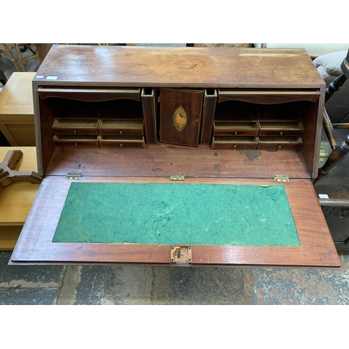 58 - A George III mahogany bureau on bracket supports - approx. 108cm high x 112cm wide x 54cm deep