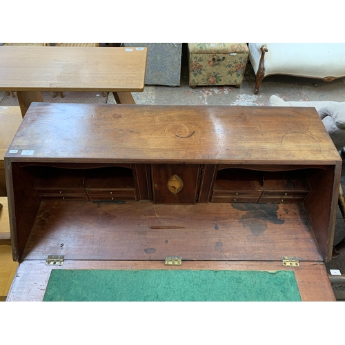 58 - A George III mahogany bureau on bracket supports - approx. 108cm high x 112cm wide x 54cm deep