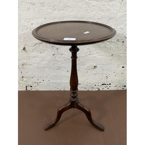 60 - A Georgian mahogany circular tripod wine table - approx. 60cm high x 34cm diameter