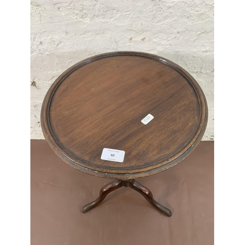 60 - A Georgian mahogany circular tripod wine table - approx. 60cm high x 34cm diameter