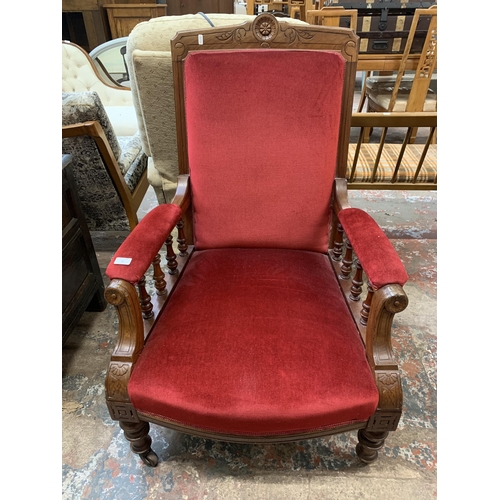 64 - A late Victorian/Edwardian carved mahogany and red fabric upholstered parlour chair on castors - app... 