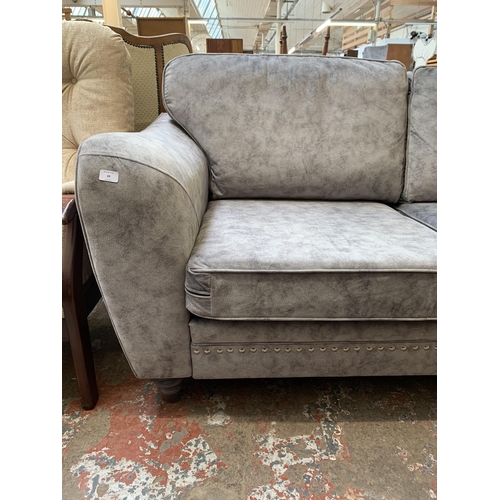 69 - A modern grey fabric upholstered three seater sofa - approx. 92cm high x 193cm wide x 94cm deep