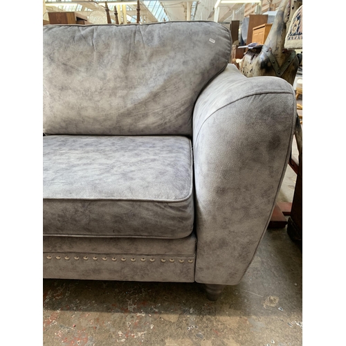 69 - A modern grey fabric upholstered three seater sofa - approx. 92cm high x 193cm wide x 94cm deep