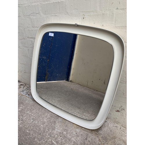 70 - A mid 20th century white plastic framed wall mirror - approx. 71cm high x 69cm wide