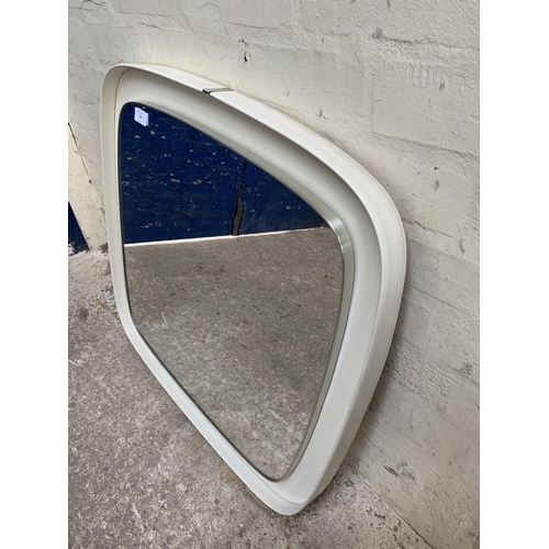 70 - A mid 20th century white plastic framed wall mirror - approx. 71cm high x 69cm wide