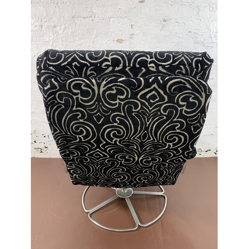 74 - A mid 20th century chrome plated and fabric upholstered swivel armchair - approx. 93cm high x 67cm w... 