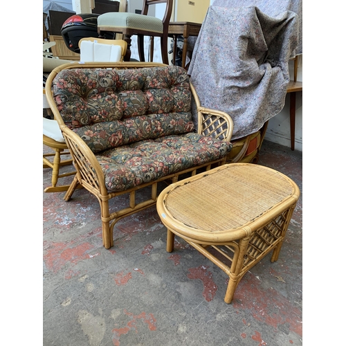 77 - A wicker and cane two piece conservatory suite comprising two seater sofa and coffee table