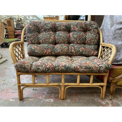 77 - A wicker and cane two piece conservatory suite comprising two seater sofa and coffee table