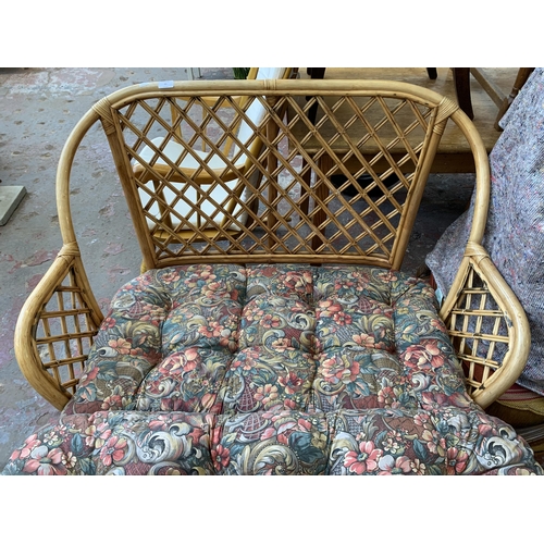 77 - A wicker and cane two piece conservatory suite comprising two seater sofa and coffee table