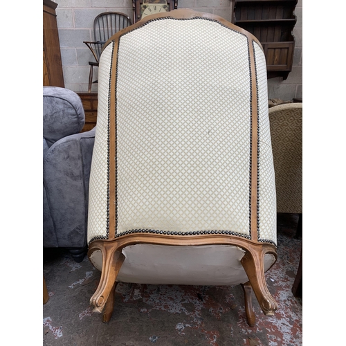 82 - A French Louis XV style beech framed and fabric button back upholstered armchair - approx. 109cm hig... 