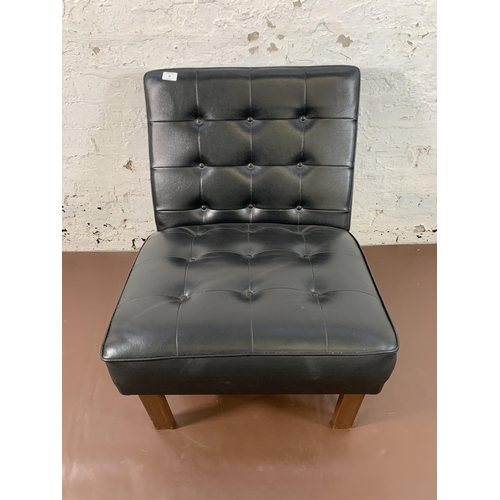 88 - A mid 20th century teak and black vinyl lounge chair - approx. 74cm high x 60cm wide x 68cm deep