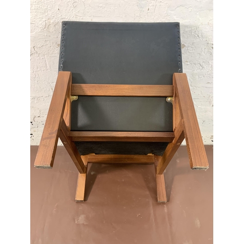 88 - A mid 20th century teak and black vinyl lounge chair - approx. 74cm high x 60cm wide x 68cm deep