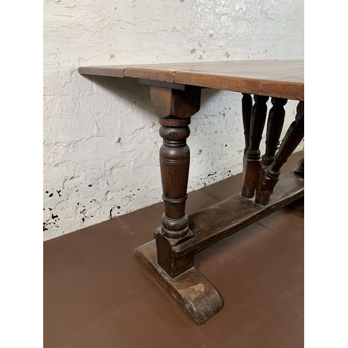 9 - A Georgian style solid oak drop leaf gate leg dining table - approx. 73cm high x 105cm wide x 102cm ... 