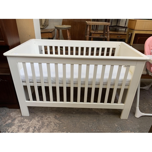 93 - A John Lewis white painted cot bed with mattress - approx. 88cm high x 82cm wide x 150cm long