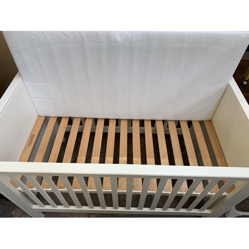 93 - A John Lewis white painted cot bed with mattress - approx. 88cm high x 82cm wide x 150cm long