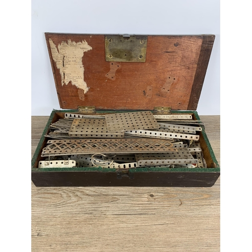 474 - A 19th century stained pine box containing a large collection of Meccano parts and accessories