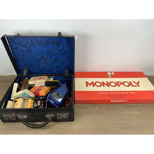 479 - A collection of vintage toys and games to include diecast model vehicles, Monopoly board game, playi... 