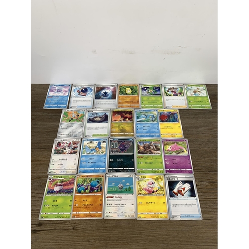 483 - A collection of Japanese Pokémon cards to include two full folders of various holographic cards