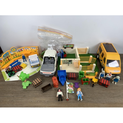 486 - A box containing a collection of Playmobil toys and accessories