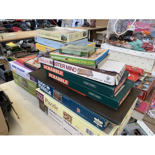 493 - A collection of boxed puzzles and board games to include Scrabble, Monopoly, 1000 piece Little Moret... 