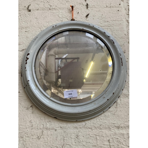 616 - A late 19th/early 20th century white painted framed circular bevelled edge wall mirror - approx. 34c... 