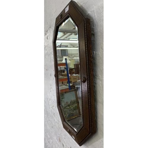 664 - An early 20th century oak framed octagon bevelled edge wall mirror - approx. 67cm x 44cm