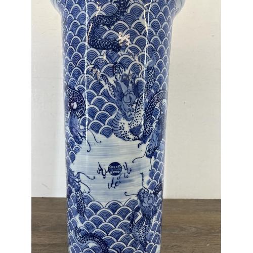 393 - A Chinese blue and white porcelain dragon pattern stick stand/vase - approx. 46cm high