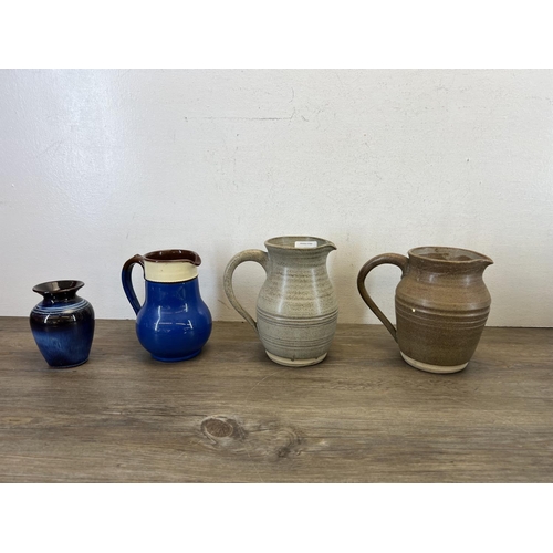 403 - A collection of ceramics and glassware to include Membury jugs, wall pocket, tiles etc.