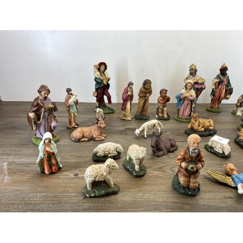 404 - A collection of nativity figurines to include plaster, ceramic etc.