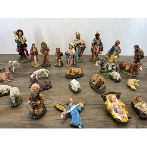 404 - A collection of nativity figurines to include plaster, ceramic etc.