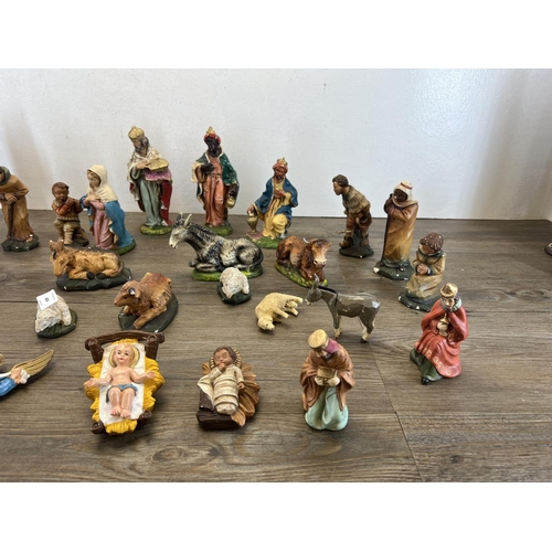 404 - A collection of nativity figurines to include plaster, ceramic etc.