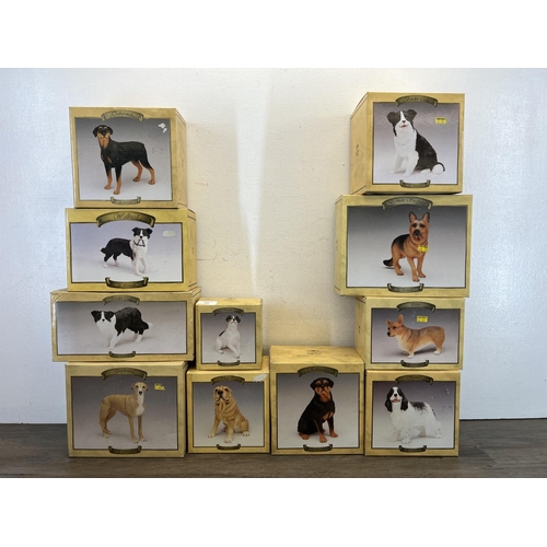 410 - Fifteen boxed The Leonardo Collection resin dog figurines