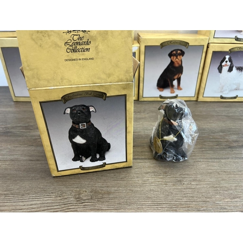 410 - Fifteen boxed The Leonardo Collection resin dog figurines