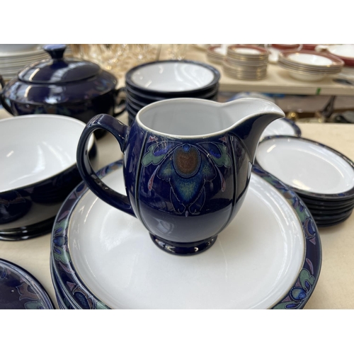 411 - A collection of Denby Baroque dinnerware to include seven cups, nine saucers, milk jug, tureen etc.